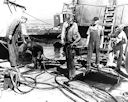 Image: USN NR&L (MOD) 39773 Members of the diving crew emerge from water-filled compartments of Arizona.