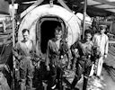 Image: USN NR&L (MOD) 39778

Divers standing in front of decompression chamber.