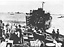 Slow Unloading--Each Carton of Rations Manhandled Twice. Apparently No Trucks or LVT's
Loaded in the LSM, Being Used. Instead Roller Conveyors Are Used