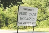 A sign advertising molasses production.