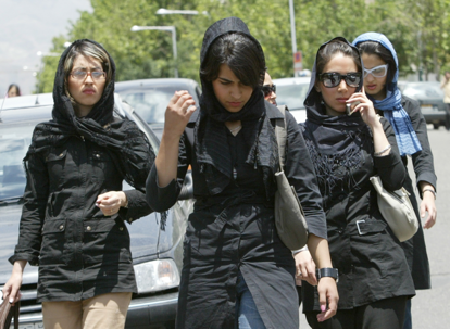 A group of young Iranian women walk outside a shopping center northwest of Tehran