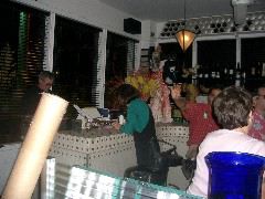 Sally pays up, Mark gestures, back of Ruby's head