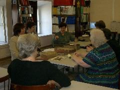 The Head Librarian gestures as others watch
