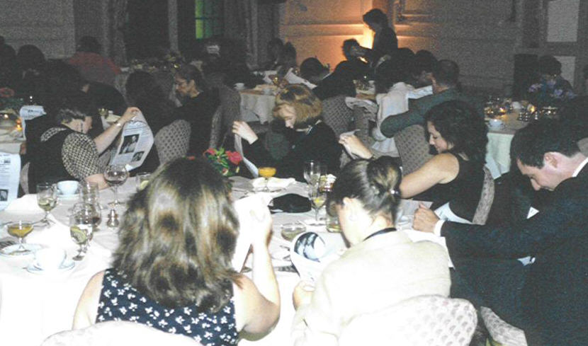 News Division members read a spoof newspaper