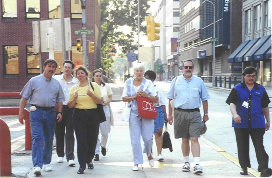 News Division members (names below) walk down the street