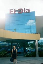 Laura Soto-Barra stands in front of El Nuevo Dia newspaper building in Santa Cruz.  Most newspaper buldings and newsrooms in Bolivia are modern and spacious. Some of their computer systems would be the envy of American newspapers, but the connections to the internet were atrocious. Telecommunications were deregulated at the end of 2001.