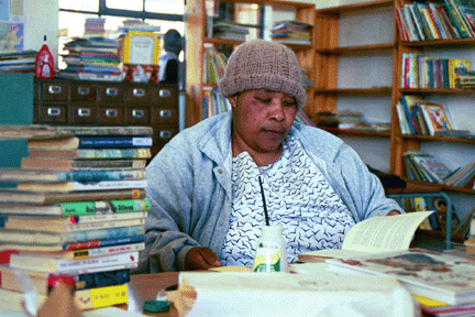 A volunteer at the library helps process books at Nottingham Road Combined School.