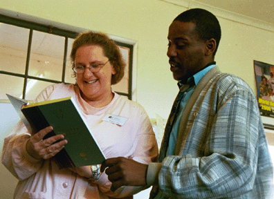 Maggie Hite, assistant director of the WLP, teaches a volunteer librarian how to use an index.
