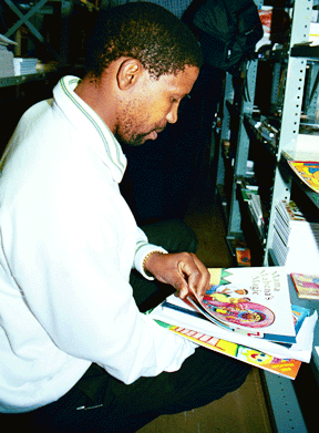 Principal Protus Sakhela selects new African books for Nottingham Road Combined School through the Book Certificate Program.