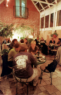 Featuring a garden-style atrium and cielings painted with murals of clouds, the dining room at Four Eleven West is a fun, informal and classy space for any occasion