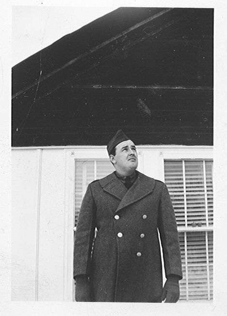 A photograph of Bill 
Hurley in his Army uniform, standing outside.