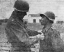Maj. Gen. Charles L. Bolte awards the Bronze Star to Pfc. John W. Kionut,
Caddo, Oklahoma, for gallantry in action.