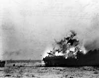 Photo # 80-G-11916:  Heavy explosion on USS Lexington blows an aircraft over the side, 8 May 1942
