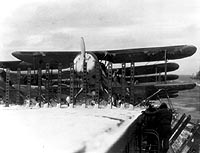 Photo # 80-G-13129:  SOC-3A aircraft parked on USS Long Island's snowy flight deck, January 1942
