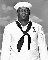 Photo # 80-G-408456:  Mess Attendant 2nd Class Doris Miller, wearing the Navy Cross, May 1942