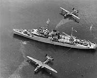 Photo # 80-G-483681:  USS Timbalier tending two Martin PBM Mariner seaplanes soon after World War II.