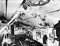 Photo # NH 41833: Interior of USS S-4's battery room in March 1928, after her salvage, showing damage received when she was sunk on 17 December 1927