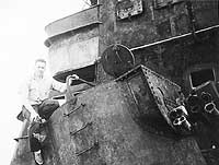 Photo # NH 51982-A:  Sailor from USS Helena poses on board the wreck of Admiral Graf Spee, February 1940