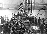 Photo # NH 83711:  The National Ensign is raised as USS New York is placed in commission, 15 April 1915
