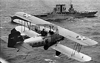 Photo # NH 94899:  )2U-2 aircraft fly past USS Saratoga while preparing to land on board, circa 1930