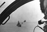Photo # NH 98300:  USS Boston fires a salvo of eight-inch shells at enemy targets, 1969