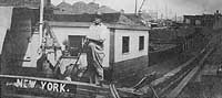 Photo #  NH 99224:  Crewman sweeping up on board the barge Bertell W. King, prior to World War I