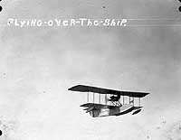 Photo # NH 99728: Aeromarine 40 flying boat flies over USS Hannibal, 1923