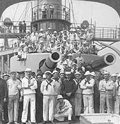 Photo # NH 100303:  Crewmen pose by USS Iowa's forward gun turret, 1898