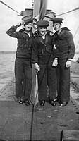 Photo # NH 103441:  Three crew members standing by USS O-7's fairwater, circa 1918-1919