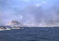 Photo # NH 104317-KN: Amphibious tractors head for the Iwo Jima landing beaches, circa 19 February 1945. Photographed by Lt. Howard W. Whalen, USNR.