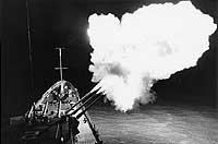 Photo # USN 1121549:  USS Canberra fires a three-gun salvo while bombarding targets in North Vietnam, March 1967