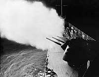 Photo # USN 1142155:  USS Oklahoma City firing her six-inch guns off Vietnam, June 1966
