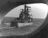 Photo # USN 1166905:  USS Oklahoma City seen through a porthole on USS San Jose, January 1976