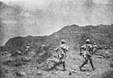 On the level top of the hill men rushing forward, during an attack on a mountain feature in Amba Alagi area