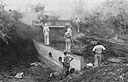 South African Engineers fill a culvert during road construction through the African bush.