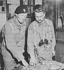 A Polish Soldier (left) and an American officer confer near Chambois