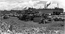 beachhead loaded with ammunition, oil drums, and other equipment
