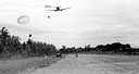 DOUGLAS TRANSPORT C-47 dropping supplies and equipment on an uncompleted airstrip