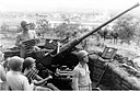 ANTIAIRCRAFT CREWS MANNING THEIR GUNS in New Guinea