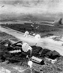 PARACHUTE BOMBS dropping from low-flying American planes during a raid over Rabaul