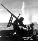 U.S. COASTGUARD GUNNERS fighting against a determined Japanese aerial attack during the invasion at Cape Gloucester