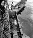 CASUALTY BEING HOISTED FROM AN LCV into a transport