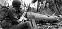 INFANTRYMAN with a Browning automatic rifle (BAR) guarding a trail