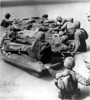 CASUALTIES BEING EVACUATED IN A RUBBER BOAT