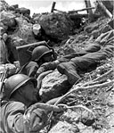 MEN STRUGGLE UP A STEEP SLOPE ON PELELIU