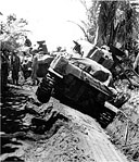 MEDIUM TANKS AND THEIR CREWS pause in their drive toward the airstrip during the first day ashore