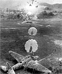 CAMOUFLAGED JAPANESE PLANE, just before it went up in flames from the approaching parafrag bombs