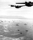 PBY CATALINA AMPHIBIAN FLYING BOATS over the U.S. invasion fleet in Lingayen Gulf