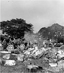105-MM. HOWITZERS M2A1 firing from the grounds of Santo Tomas University during the attack on Manila