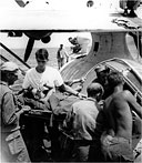 BATTLE CASUALTY being placed aboard a Catalina flying boat for evacuation to Nichols Field